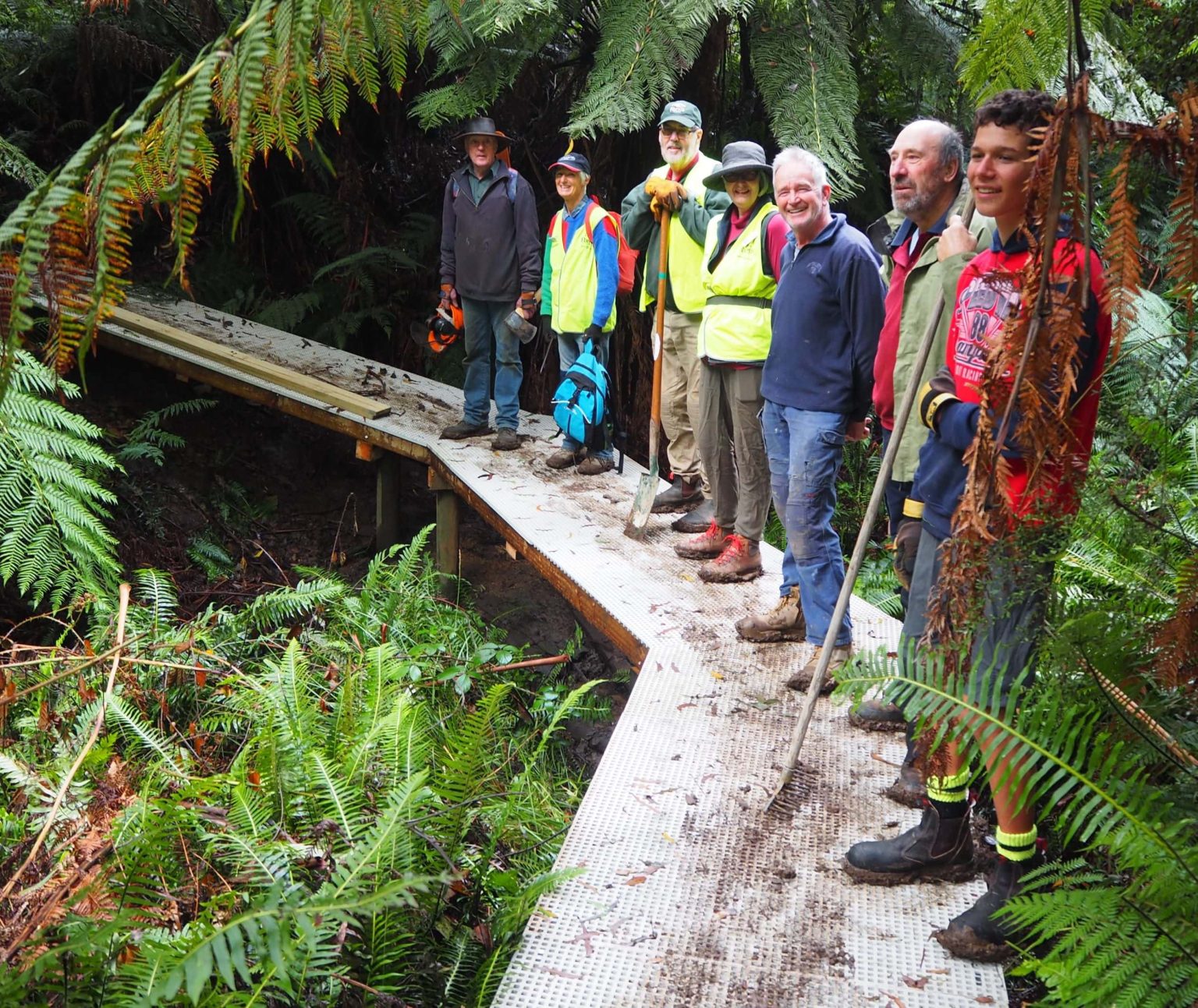 FoMW Happy smiles after finishing the new walkway over a boggy creek crossing MtWorth Friends